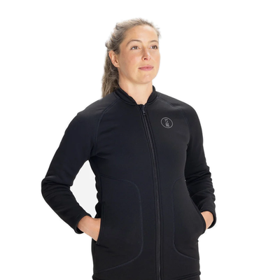 Women's Fourth Element Arctic top in black worn front on with hands in the side pockets
